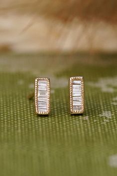 Shimmering baguette diamonds are all lined up and framed in a milgrain rectangle. The whole earring is 14k yellow gold and perfect for everything from bridal jewelry to daily wear. These little studs are 6.5mm long and 2.5mm wide. Not exactly what you're looking for? Check out our customs page. Available to try on in our Boulder, Colorado jewelry store. Rectangular Baguette Diamond Earrings, Rectangular Baguette Diamond Earrings For Anniversary, Classic Baguette Diamond Jewelry In Rectangular Shape, Classic Rectangular Baguette Diamond Jewelry, Classic Jewelry With Baguette Diamonds In Rectangular Shape, Timeless Rectangular Jewelry With Rose Cut Diamonds, Rectangular Baguette Diamond Jewelry, Classic 14k Gold Earrings With Baguette Diamonds, Gold Rectangular Earrings With Baguette Diamonds