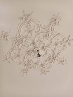 an ornate ceiling with white paint on it