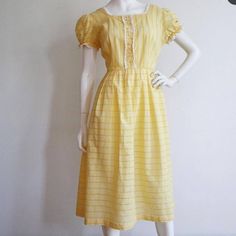 Bust: 42-44" Waist: 32-33" Hips: free Length: 45" Excellent condition, but missing a few rhinestone details in the front buttons. 1950s Style Yellow Vintage Dress For Spring, 1950s Style Vintage Yellow Dress For Spring, Yellow Vintage Dress 1950s Style For Spring, Yellow Vintage Dress, 1950s Style For Spring, Knee-length Yellow Vintage Summer Dress, Knee-length Yellow Vintage Dress For Summer, Yellow Knee-length Vintage Summer Dress, Yellow Knee-length Vintage Dress For Summer, Yellow Retro Vintage Dress For Garden Party