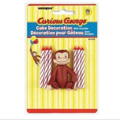 a package of curious george cake decoration with candles