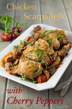 chicken scampella with cherry peppers on a white plate