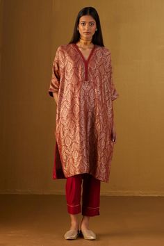 Red kaftan in Mughal brocade with floral patterns and minimal zardozi embroidery. Comes with red cotton silk pant.
Components: 2
Type Of Work: Floral
Neckline: V Neck
Sleeve Type: Three Quarter
Fabric: Kurta: Brocade and Handloom tissue, Pant: Cotton Silk, Lining: Shantoon
Color: Red
Other Details: 
Lace trims
2 pockets on kaftan and pant
Partially elasticated waistband
Length:
Kaftan: 41 inches
Pant: 36 inches
Model height: 5ft 9inches, wearing size M
Note: Dupatta worn by the model is not for Cotton A Line Dress Indian, Kaftan With Sleeves, Pakistani Kaftan Suits, Red Brocade Suit, Brocade Kurta Designs, Kaftan Suit Design, Brocade Kurti Design, Banarasi Outfits, Brocade Dress Styles