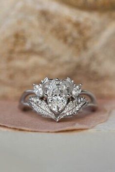 a close up of a diamond ring on a cloth