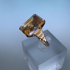 Rétro 10k Gold Yellow Gold Ladies Ring Large Emerald Cut Golden Citrine Cocktail Ring Art Deco Style Statement Ring * Vintage 10K Yellow Gold Emerald Cut Citrine November Anniversary Cocktail Ring * Ring size: 6.5  * One Emerald Cut Citrine measures approximate 17.0 mm x 12. 0 mm * Ring weight: 5.1 grams * Marked: 10K * Ring can be resized  * Condition: very good pre loved  WITH TRACKING & $100.00 INSURANCE  LET ME KNOW IF ADDITIONAL INSURANCE IS REQUIRED  FREE SHIPPING TO CANADA & USA  INTERNAT Faceted Topaz Ring In 14k Yellow Gold, Art Deco Gold Sapphire Ring In 14k Gold, Gold Art Deco Sapphire Ring In 14k Gold, Art Deco 14k Gold Sapphire Ring, Art Deco Yellow Gold Sapphire Ring For Gift, High Luster Vintage Ring Jewelry, Gold Hallmarked Ring With Rectangular Stone, Vintage Faceted Yellow Gold Rings, Gold Ring With Rectangular Stone And Hallmarked