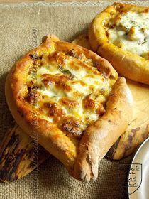 two pizzas sitting on top of wooden cutting boards