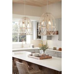 three lights hanging over a kitchen island