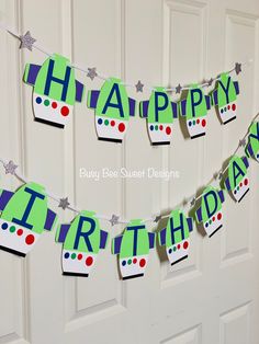 a happy birthday banner hanging from the front door with a train theme and stars on it