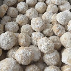 a pile of powdered donuts sitting on top of a table