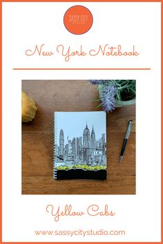 the new york notebook is shown on a table next to a pen and some flowers