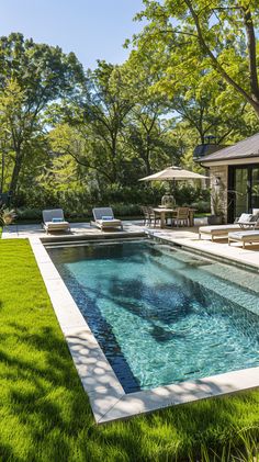 an outdoor swimming pool surrounded by grass