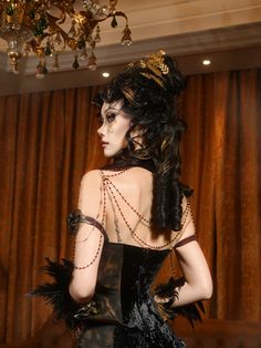 Elevate your dark elegance with our Black and Gold Victorian Goth Boned Corset. This exquisite piece features a structured, boned design that cinches the waist for a dramatic hourglass silhouette. The luxurious black fabric is contrasted by intricate gold detailing, adding a touch of regal sophistication. Adorned with removable gold roses along the hemline, this corset offers versatility and a customizable look. Perfect for gothic events, Victorian reenactments, or simply making a bold fashion s Elegant Halloween Costume Corset, Gothic Boned Bodice Corset For Formal Occasions, Gothic Formal Corset With Boned Bodice, Steampunk Black Party Corset, Black Steampunk Corset For Party, Elegant Halloween Corset For Costume Party, Elegant Fitted Halloween Corset, Elegant Halloween Fitted Corset, Gothic Corset With Corset Back For Formal Occasions