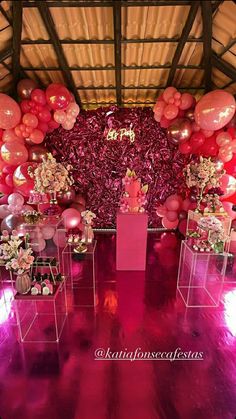 an arrangement of balloons and flowers are on display