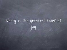 the words worry is the greatest thief of joy written on a blackboard