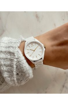 Gleaming goldtone markers and indices add a flash of sophistication to this dazzling white ceramic bracelet watch. Ceramic Imported Watches Women Aesthetic, Aesthetic Watches For Women, Mvmt Watches Women, Wrist Watches For Women, Movado Womens Watch, White Watches Women, Homemade Pillows, Classic Jewelry Pieces, Mvmt Watches