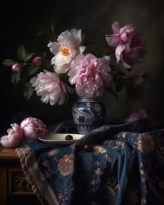 a vase filled with pink flowers sitting on top of a table