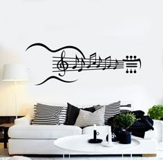 a living room with a white couch and musical notes on the wall