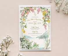 a wedding card with flowers and lemons on it next to some baby's breath