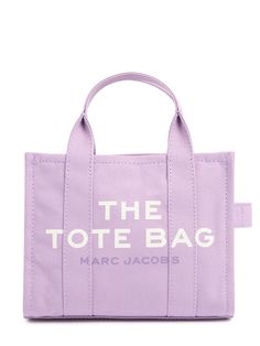 Height: 21cm Width: 26cm Depth: 13cm. Detachable strap,Drop: 51cm. Double top handles,Drop: 10cm. Top zip closure. Printed front panel. Back logo patch detail Marc Jacobs Tote Bag Medium, Lilac Design, Purple Tote, Purple Tote Bag, Marc Jacobs Handbag, Medium Tote Bag, Marc Jacobs Tote, Small Tote Bag, The Tote Bag