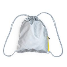 a silver drawsack bag sitting on top of a white surface with a string attached to it