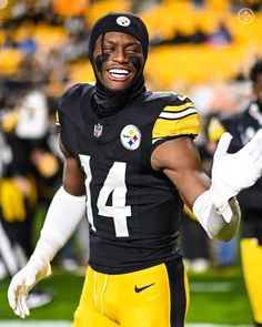 a football player wearing a black and yellow uniform