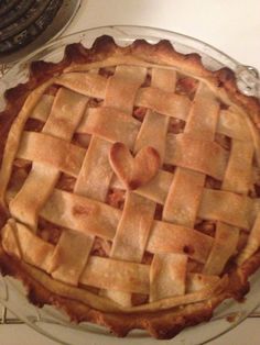 a heart shaped pie sitting on top of a glass plate