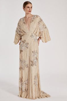 Part of The Royal School of Needlework x Coast collection. Adorned with shimmering embellishments for a striking finish, inspired by the Kyoto artwork, this bridal dress is made for the most glamorous of brides. Designed in a waist-defining fit with a plunging V-neckline, stylish kimono sleeves and a floor-sweeping maxi length. ​ The Royal School of Needlework was founded in 1872, to revive the beautiful artform of embroidery. This new bridal collection has been inspired by the Royal School of N Kimono Wedding Dress, Royal School Of Needlework, Hanfu Style, Mog Dresses, Stylish Kimono, Royal School, Bar Mitzva, Kimono Sleeve Dress, Kimono Style Dress