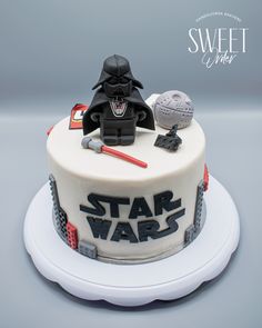 a star wars themed birthday cake with darth vader and stormtrooper on top