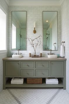 a bathroom with two sinks, mirrors and towels on the counter top next to each other