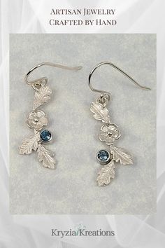 Wear the blue and white colors of winter with these flower dangle earrings where flowers and oak leaves are frozen in time by winter's first frost in shimmering sterling silver and set with London blue Topaz.  See more, and shop these artisan-made earrings at www.KryziaKreationsStudio.com Garland Flower, Winter Garland, Flower Dangle Earrings, Frozen In Time