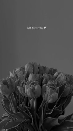 a black and white photo of flowers in a vase with the words love between us on it