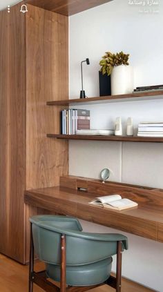 a wooden desk sitting next to a book shelf