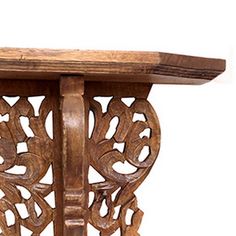 an old wooden table with carvings on the top and bottom edge, against a white background