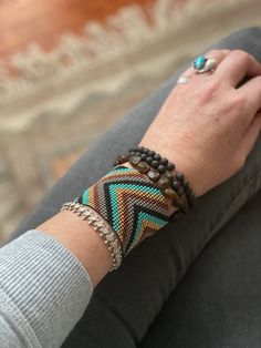 a woman's arm with several bracelets on it