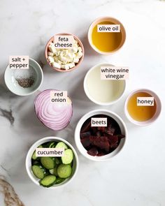 bowls filled with different types of food on top of a white marble countertop and labeled in words