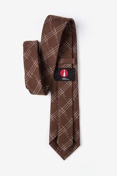 Update your wardrobe with the Escondido tie. This brown accessory features a loose checkered pattern perfect for the office and semiformal events. Imported. Classic Brown Ties For Office, Brown Standard Tie For Business, Dapper Brown Tie For Business, Brown Semi-formal Standard Tie, Classic Plaid Suit And Tie Accessories For Office, Brown Standard Tie, Brown Accessories, Brown Tie, Update Your Wardrobe