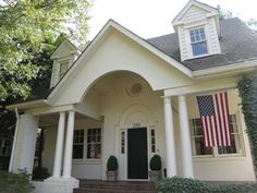 a white house with an american flag on the front door