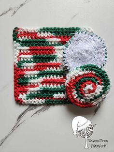 a crocheted red, white and green dishcloth on a marble counter top