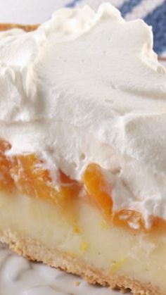 a piece of pie with whipped cream on top sits on a blue and white plate