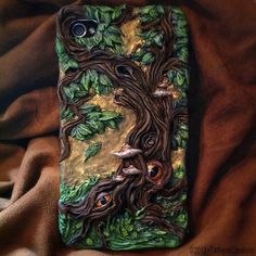 a cell phone case with an image of a tree and birds on it's back