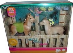 two toy horses in a box with palm trees