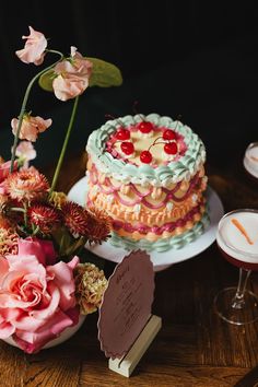 there is a cake and flowers on the table