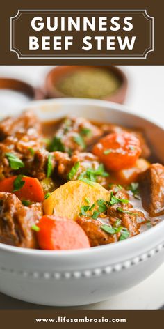 a close up of a bowl of food with text overlay that reads guinness beef stew