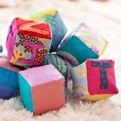 a pile of colorful blocks sitting on top of a white rug