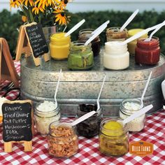 an assortment of condiments are displayed on a table