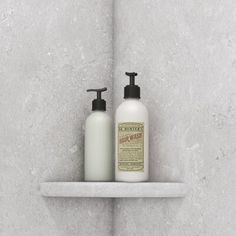 two bottles of soap and lotion on a shelf