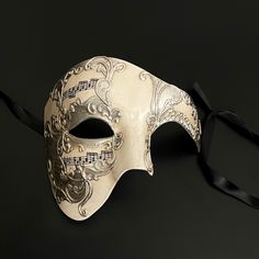 The Phantom mask, known for its association with Venetian parties and extravagant operas that exude history, would also make you stand out in any other gathering. Luxury Masks For Costume Party, White Masquerade Mask For Carnival Festivals, Full Face Theater Masks For Halloween, Festival Eye Masquerade Mask, Carnival Formal Eye Mask, Baroque Masquerade Mask For Festivals And Parties, Baroque Masquerade Mask For Parties And Festivals, Venetian Masks For Masquerade Festivals, Baroque Masquerade Mask For Festivals