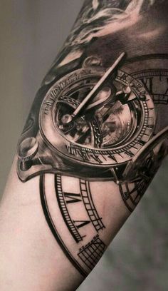 a man's arm with a clock tattoo on it