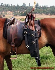 a brown horse standing on top of a lush green field