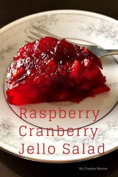 a piece of raspberry cranberry jello salad on a plate with a fork