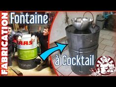 a large metal barrel sitting in the middle of a kitchen next to a green bucket